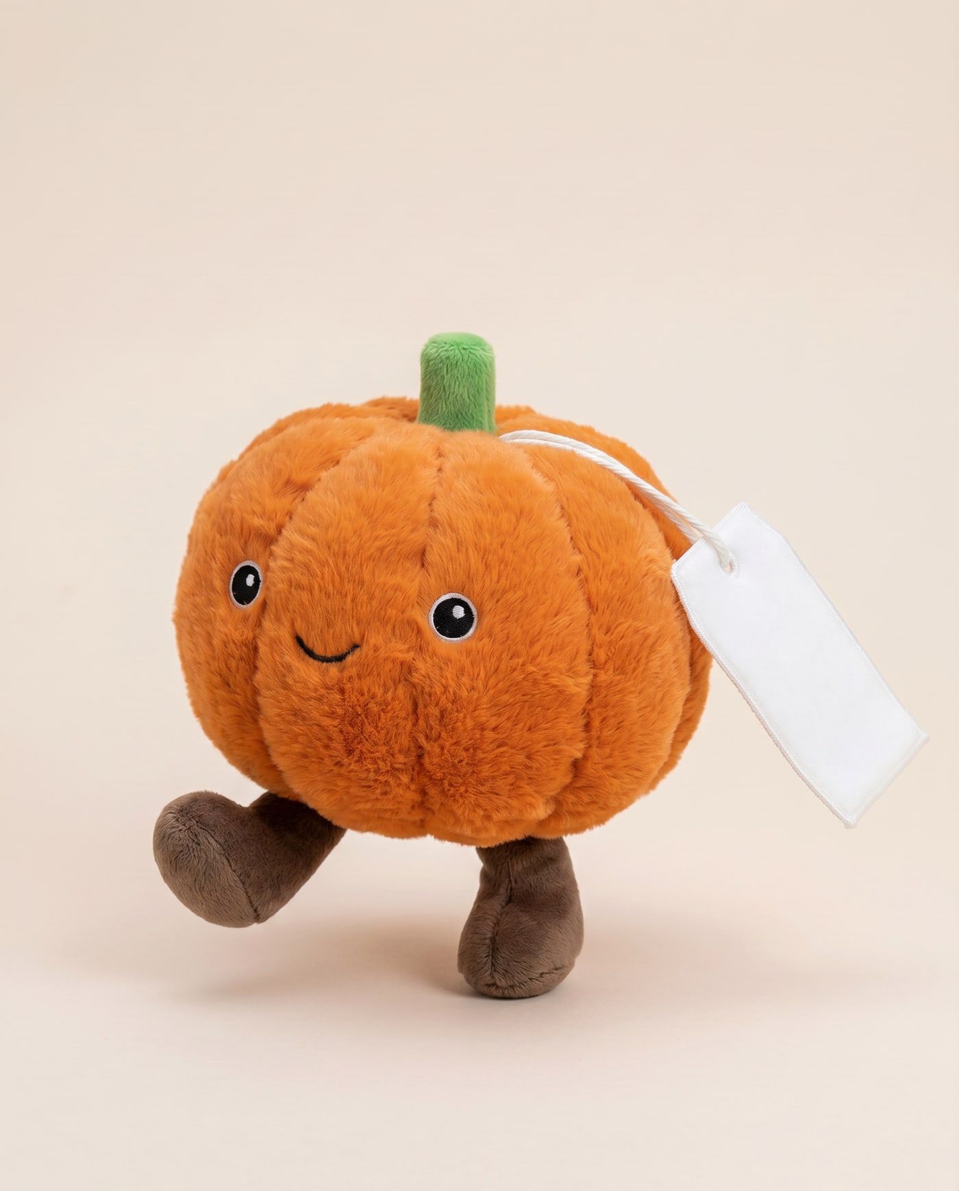 Patch the Pumpkin TagTales plush standing on a cream background, with the blank white fleece personalisation tag hanging from a cord